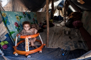  Kid in a tent in the Domiz camp. According to UNICEF and HCR, children represent 50 percent of all the Syrian conflict refugees.