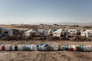  View of the Domiz refugee camp with water containers at foregound.